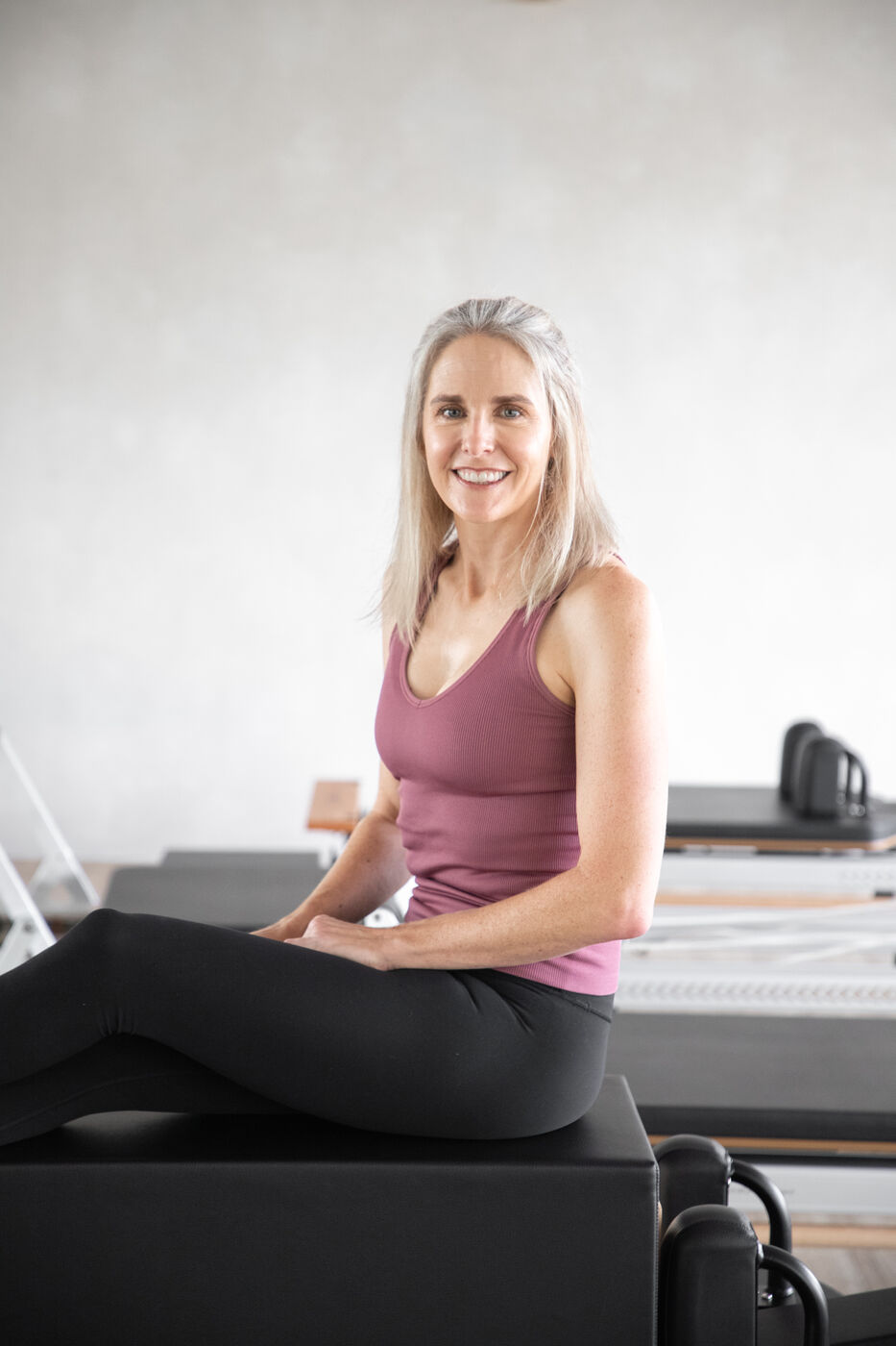 Portrait of a woman smiling in a pilates studio