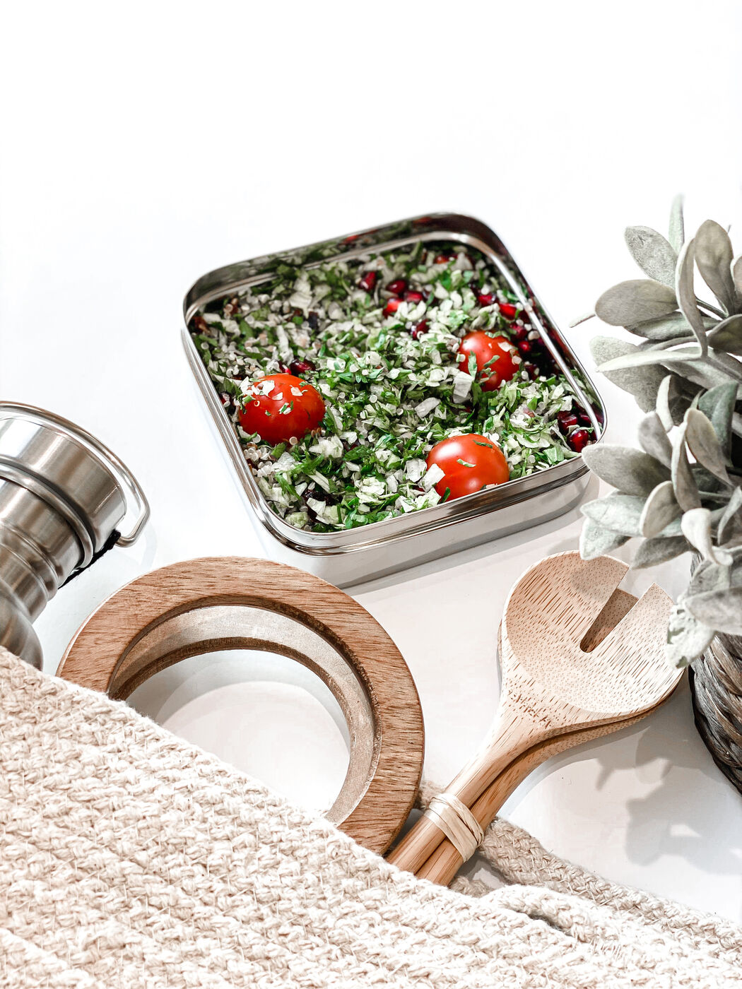 Tabbouleh salad with cherry tomatoes in a stainless steel tin